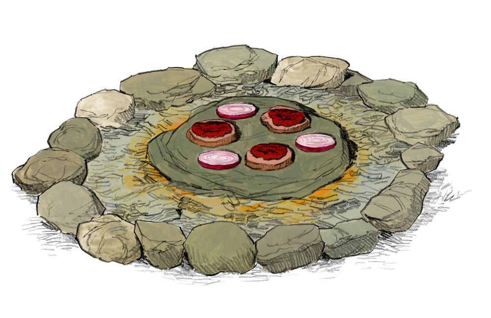 Cooking venison steaks on a rock over a flame